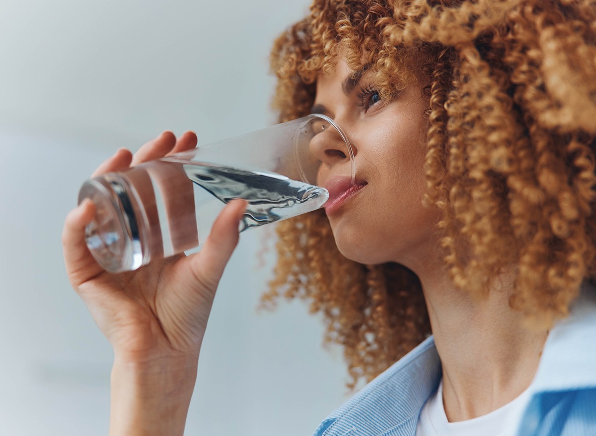 A woman drinking water from a glass 
