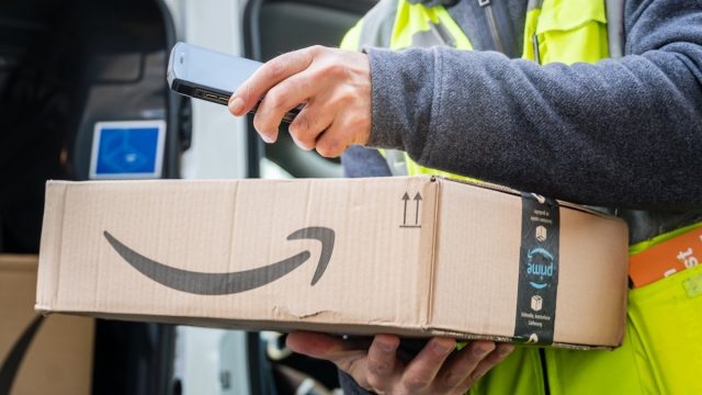 delivery person scanning amazon package