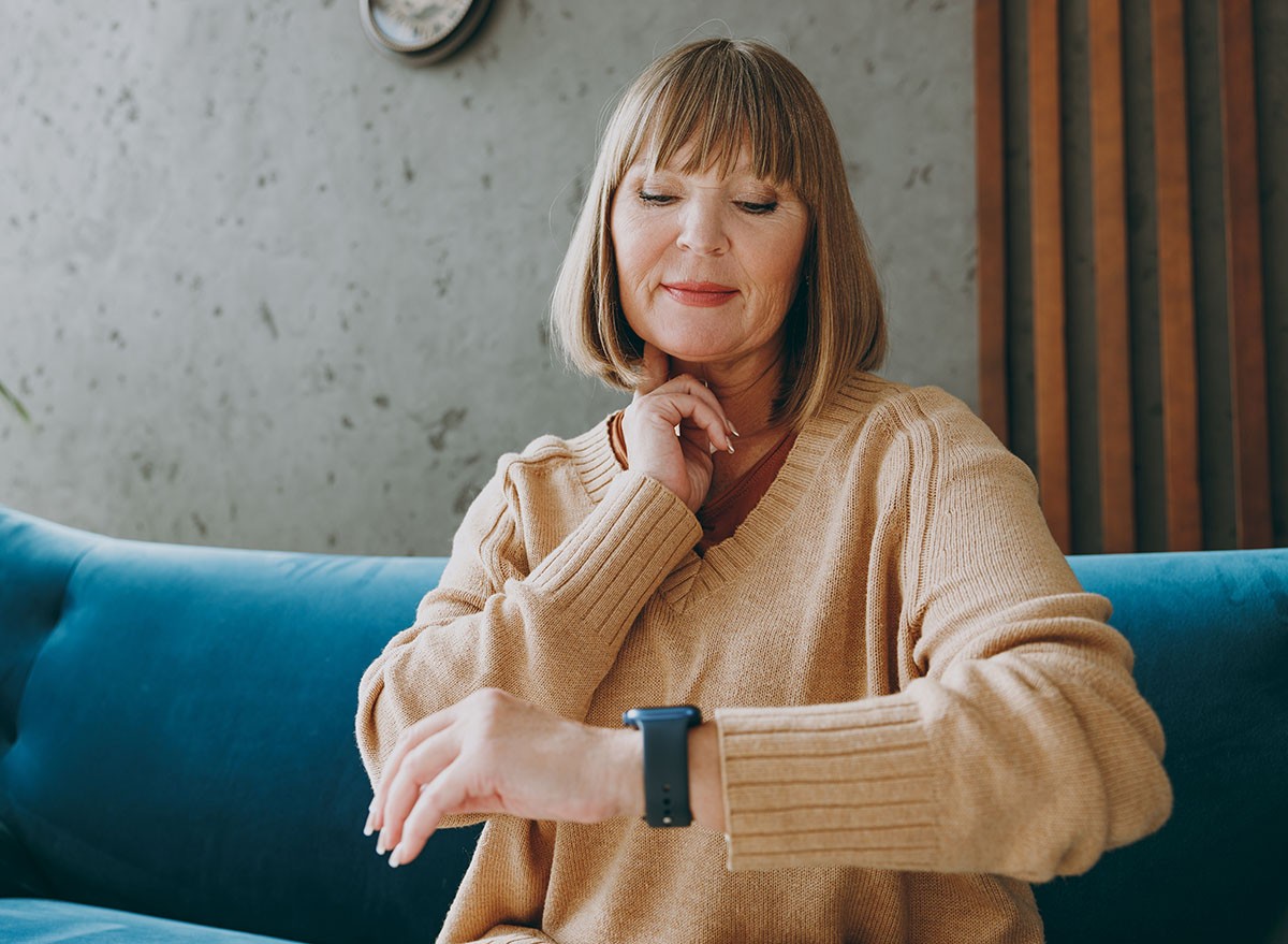 Woman at home measuring her resting heart rate