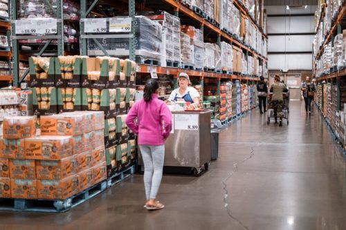 woman taking a free sample at Costco