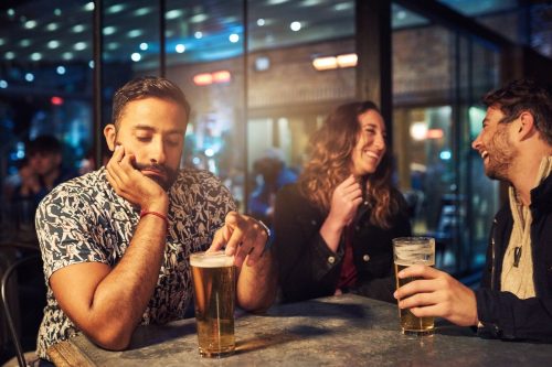 woman ignoring her date at the bar, talking to another man
