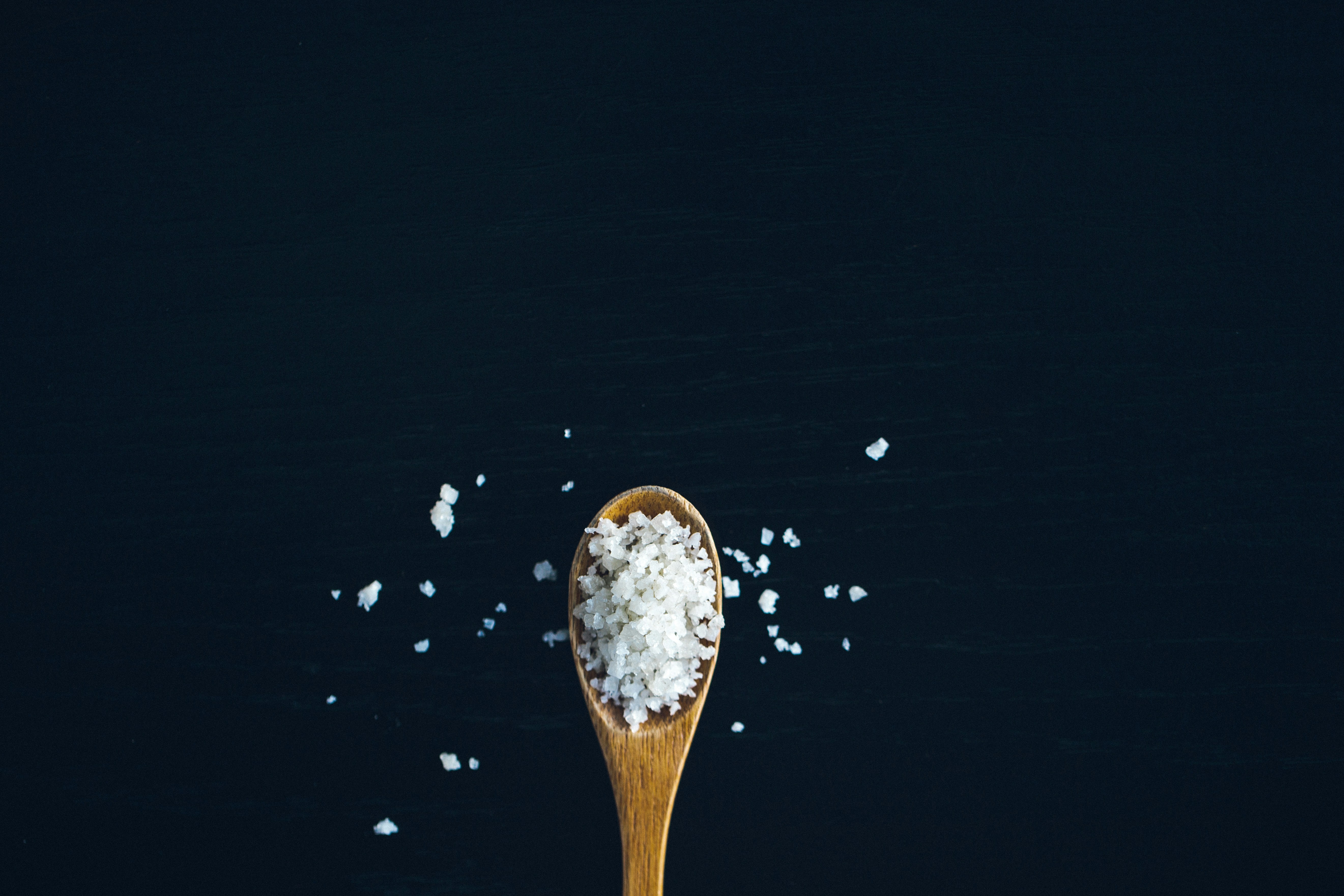 Sodium on a spoon, detrimental to blood pressure and heart health.