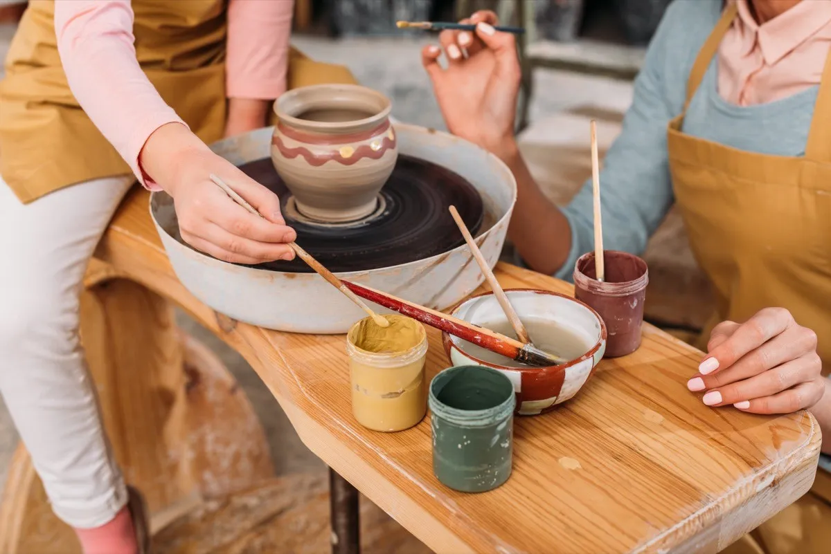 mother and daughter making pottery