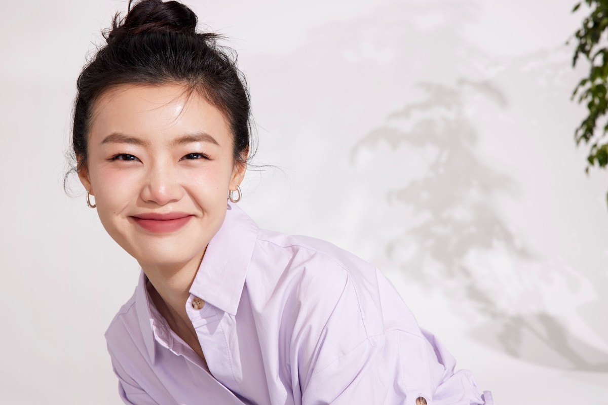 young woman wearing a purple shirt