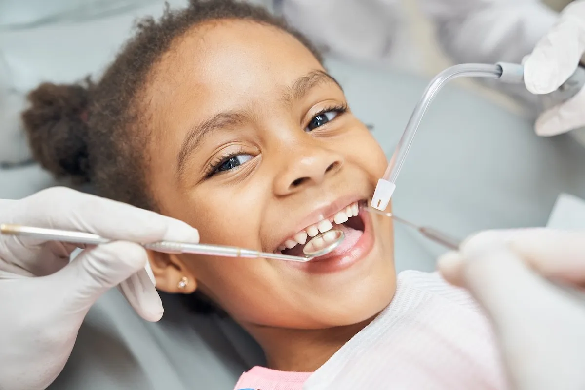 female child smiling during a dental exam