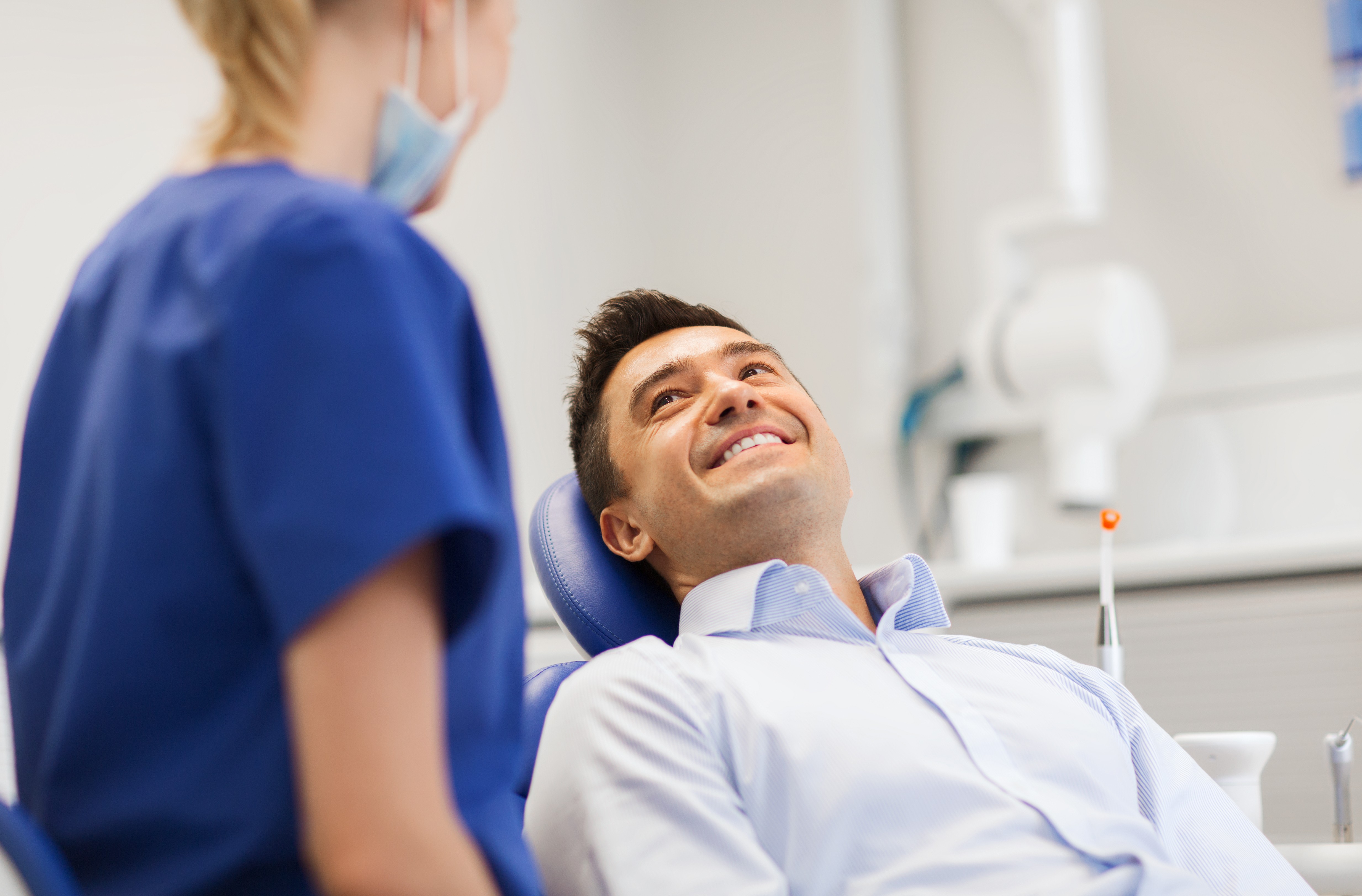 man smiling up at his dentist
