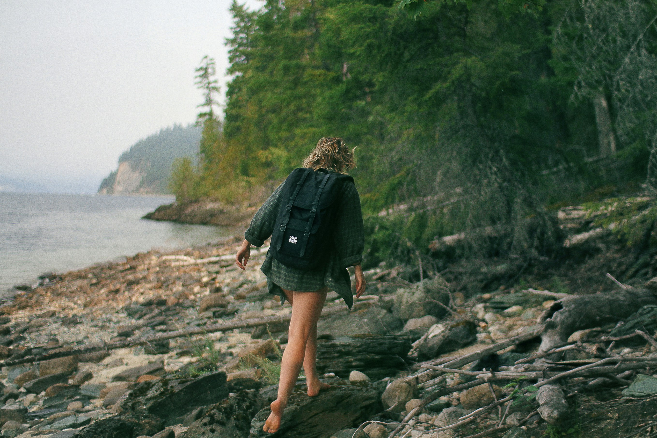a woman walks in a national forest in Canada