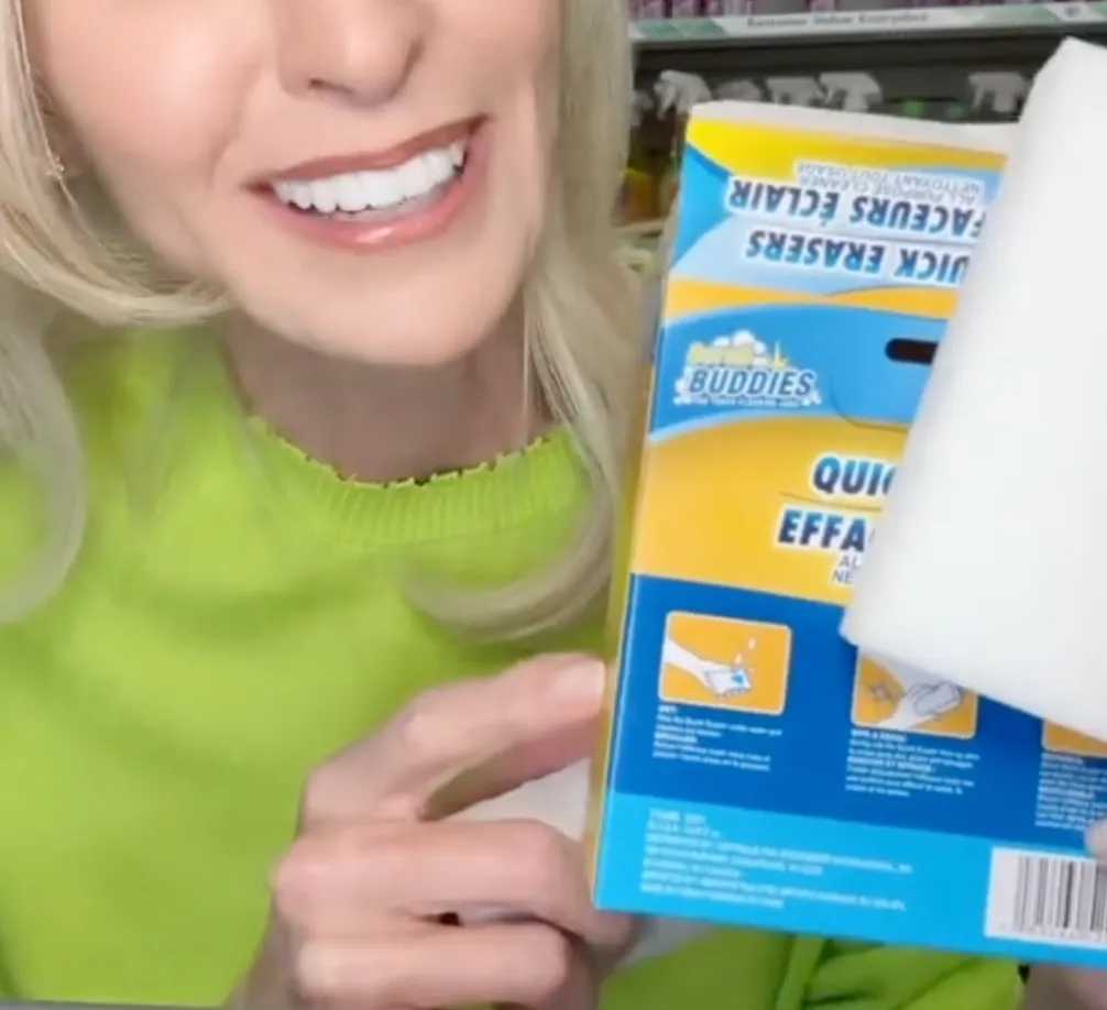 woman holding up a box of Scrub Buddies Quick Eraser at Dollar Tree