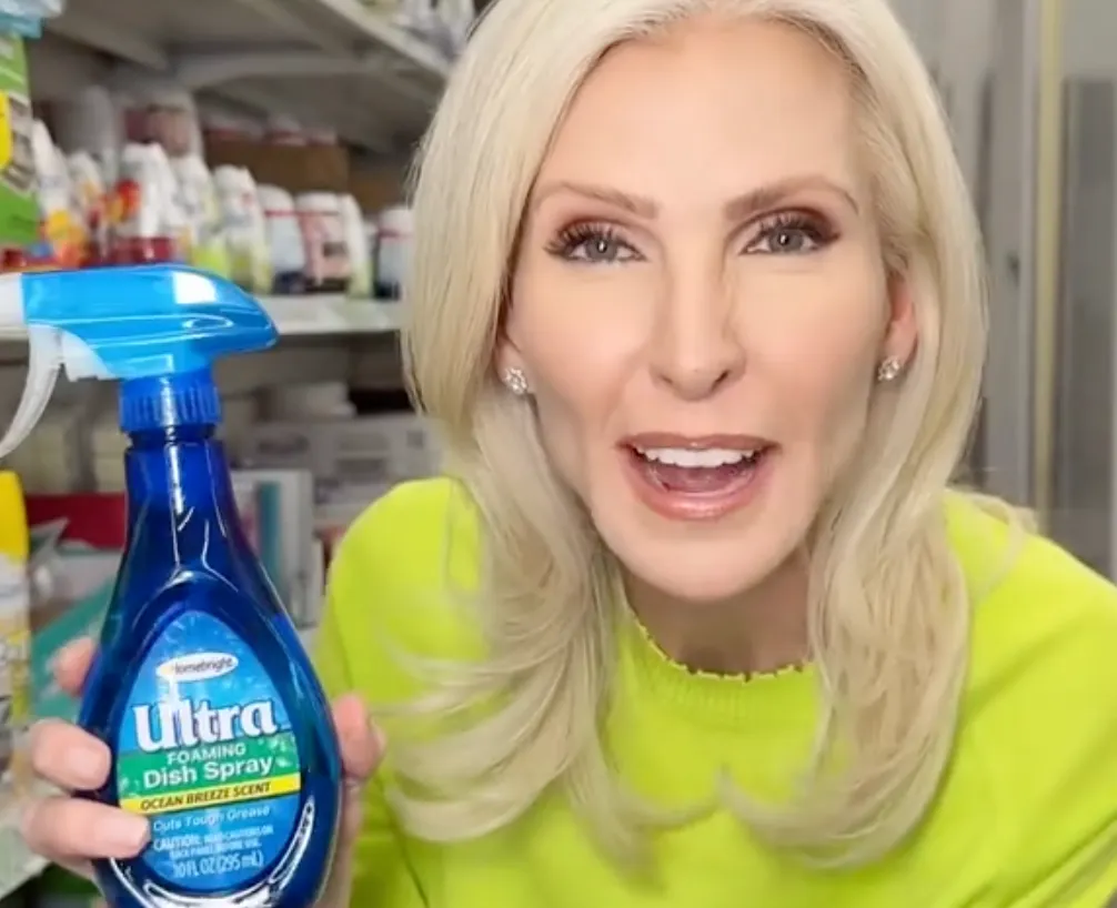 female shopper holding up a bottle of Homebright dishwashing spray from Dollar Tree