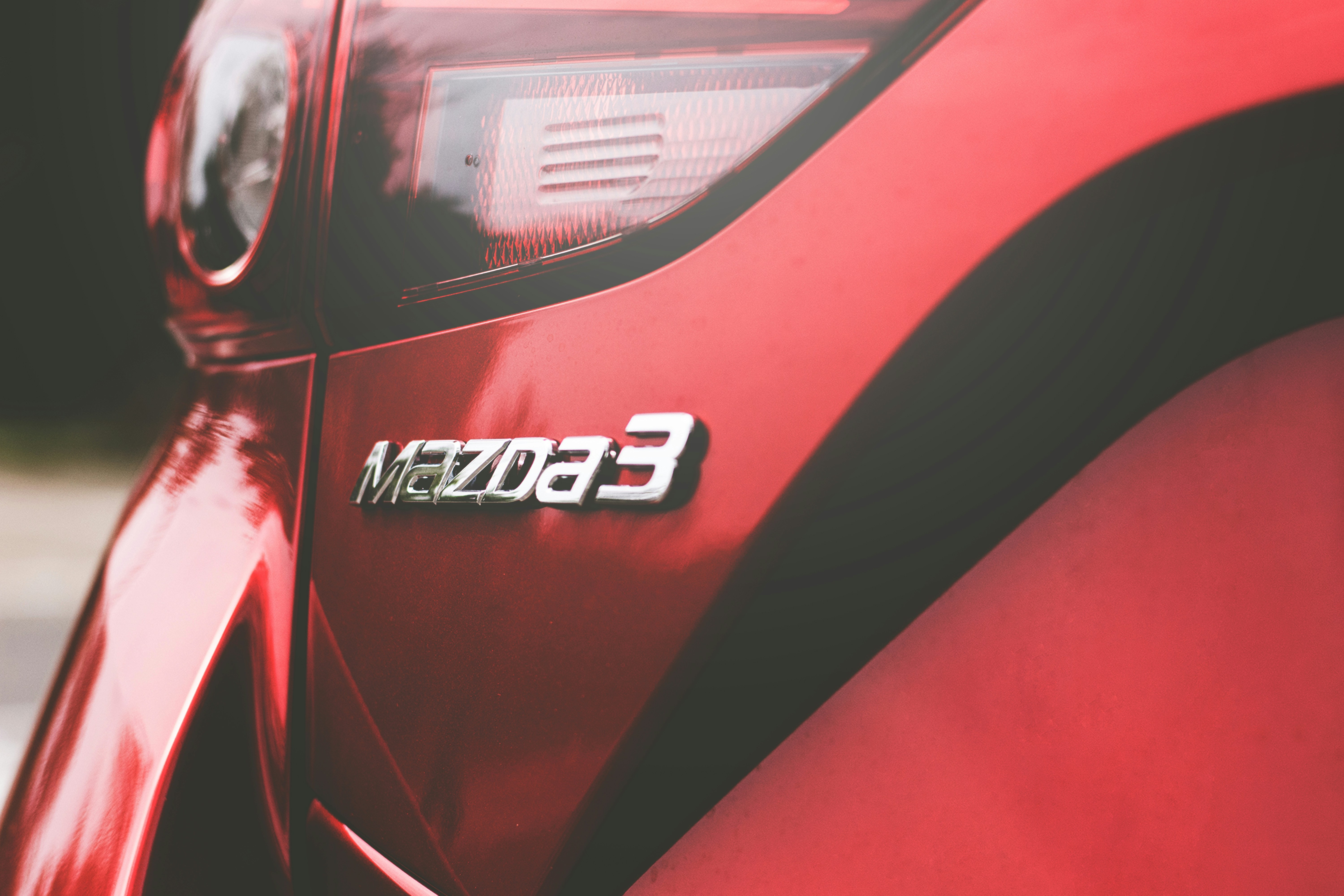 a mazda3 logo up close on a car