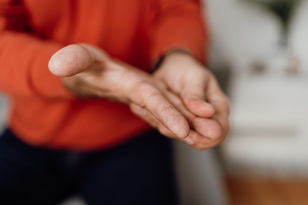 Close up unrecognizable man massaging his hand and fingers