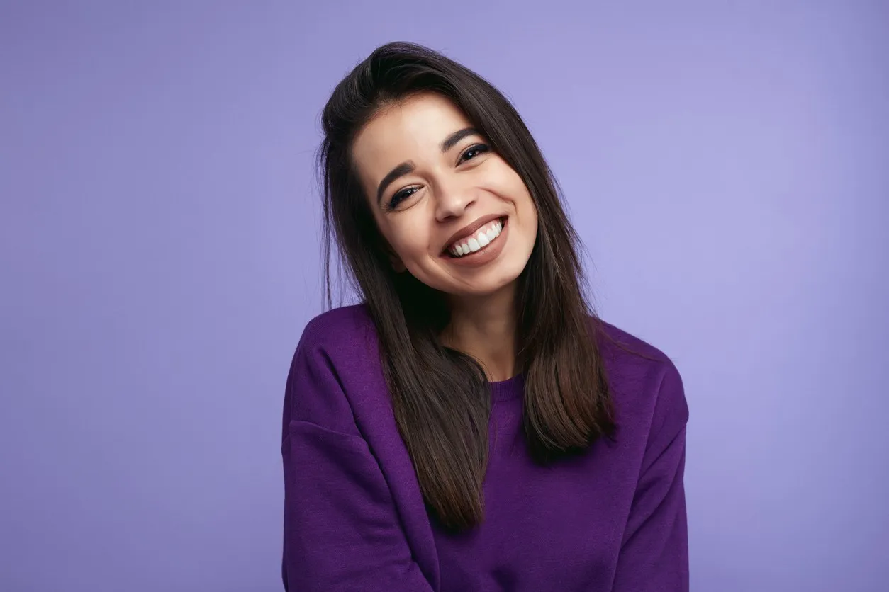 woman wearing purple sweater against purple background