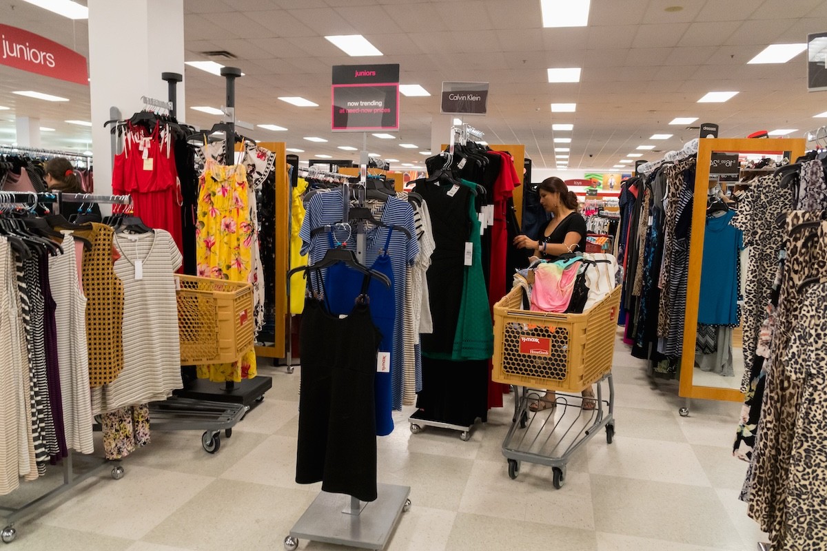 woman shopping with cart in clothing section of T.J. Maxx