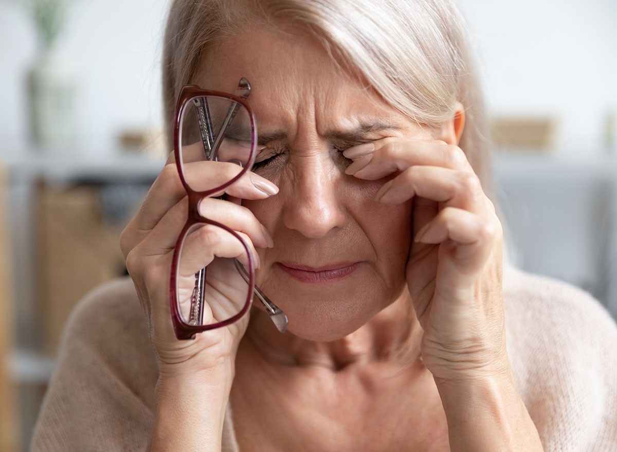 A woman having trouble with her vision rubs her eyes
