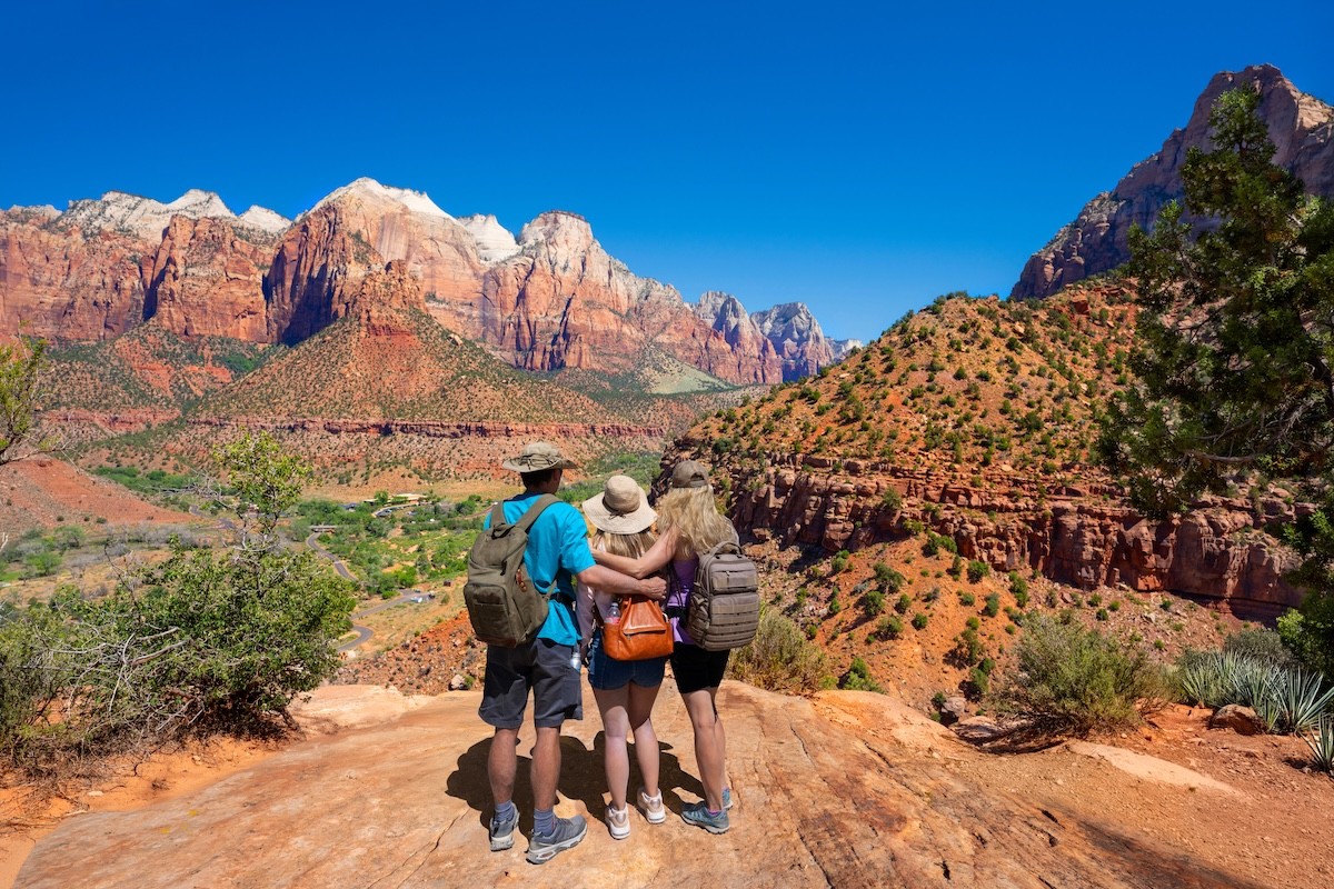 rear view of a family embracing while hiking at Zion National Park