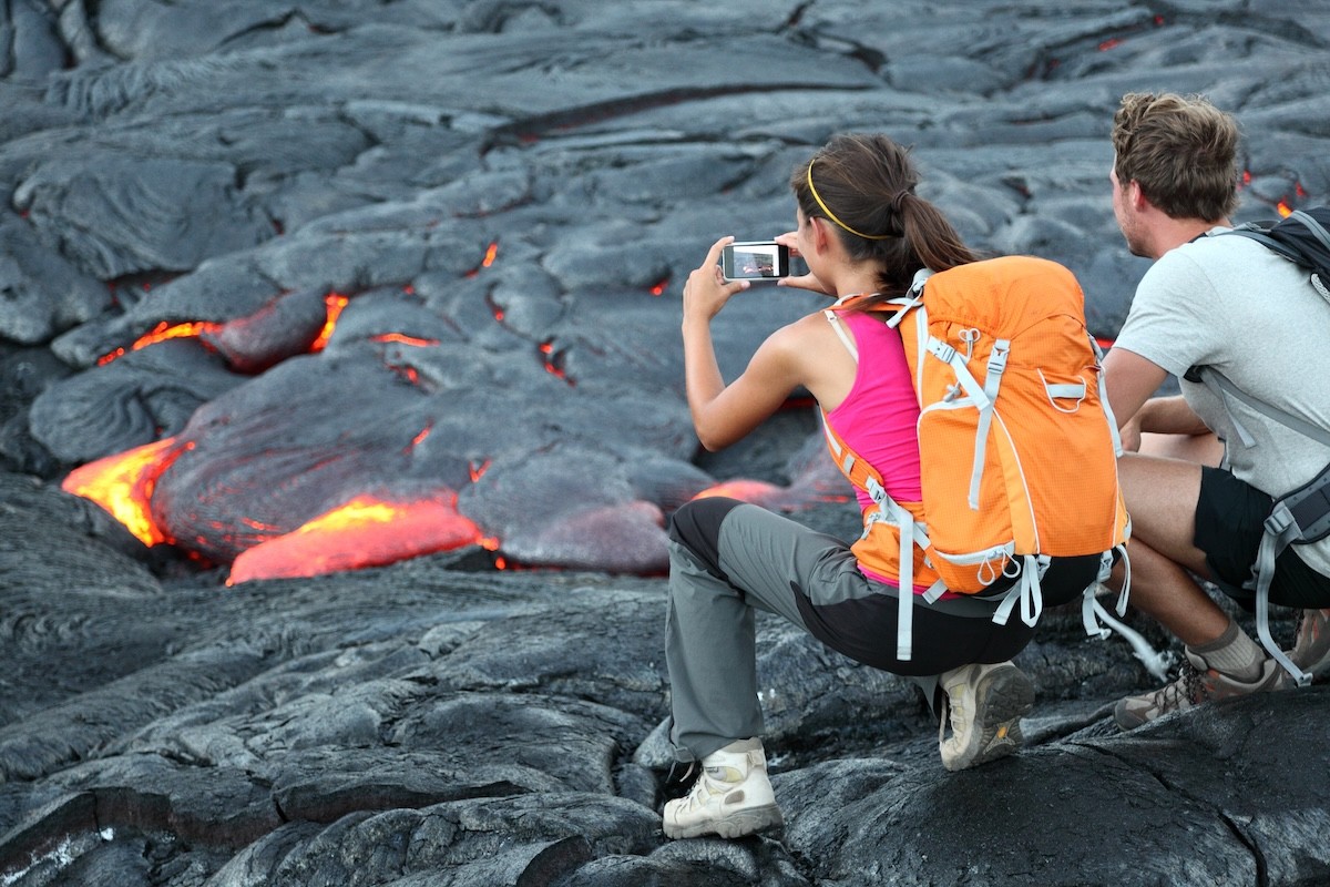 hikers photographing lava at Hawaii Volcanoes National Park