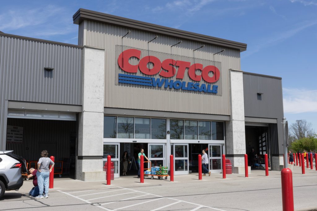 A Costco storefront with customers