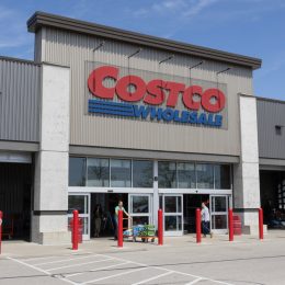 A Costco storefront with customers
