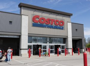 A Costco storefront with customers