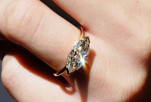 east-west diamond engagement ring on hand