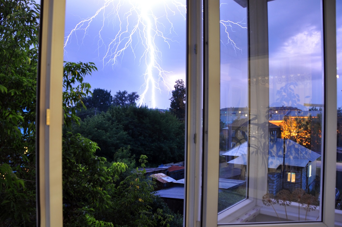 view out of a house window of a lightning bolt
