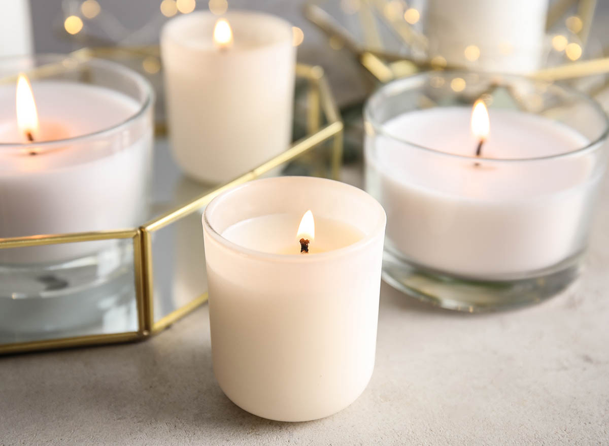 Burning aromatic candles in holders on table