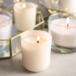 Burning aromatic candles in holders on table