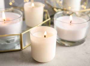 Burning aromatic candles in holders on table