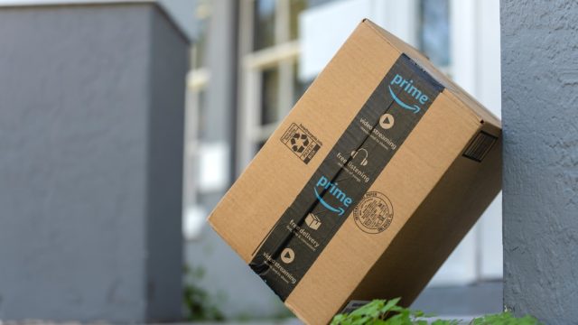 An Amazon box leaning against a pillar