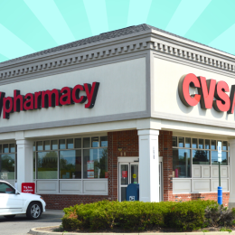 a CVS storefront with a seafoam green background