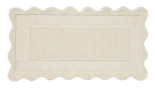cream scalloped accent rug