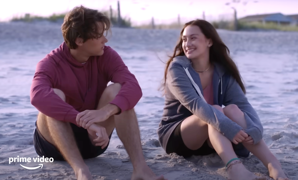 Still of Conrad and Belly sitting on the beach in The Summer I Turned Pretty