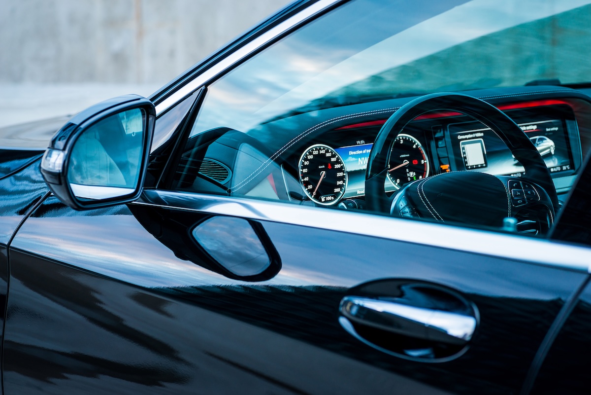 view in the driver's side window of a black car