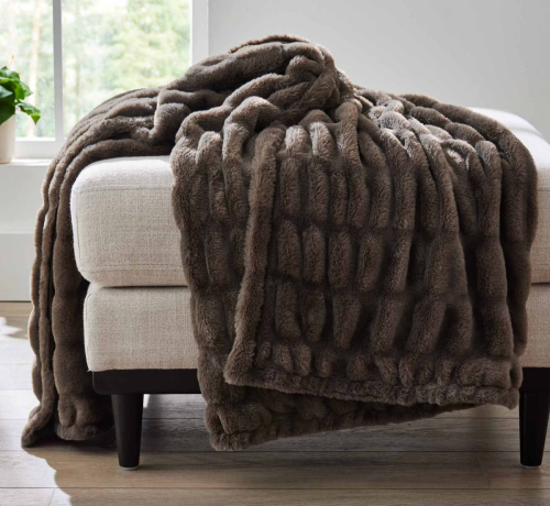brown throw blanket on an ottoman
