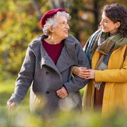 young woman walking in the park with her grandmother