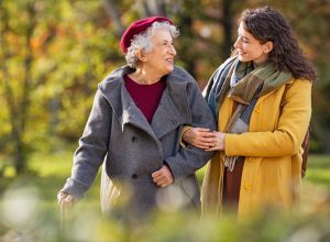 young woman walking in the park with her grandmother