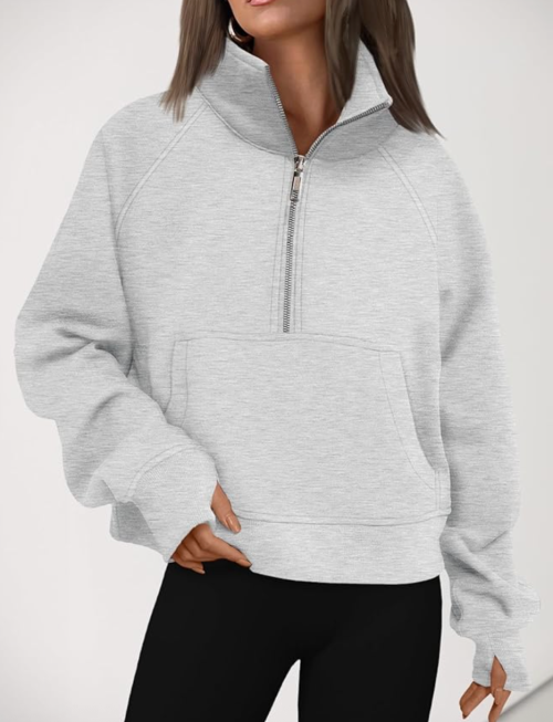 woman in a gray half-zip sweatshirt