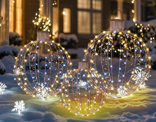 LED Christmas ornament decorations on a snowy lawn