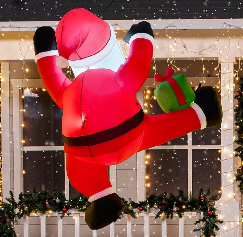 Santa inflatable on house decorated for Christmas