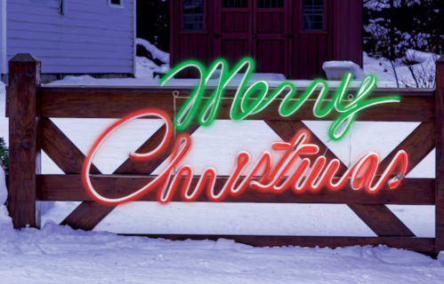 Merry Christmas neon sign on a fence