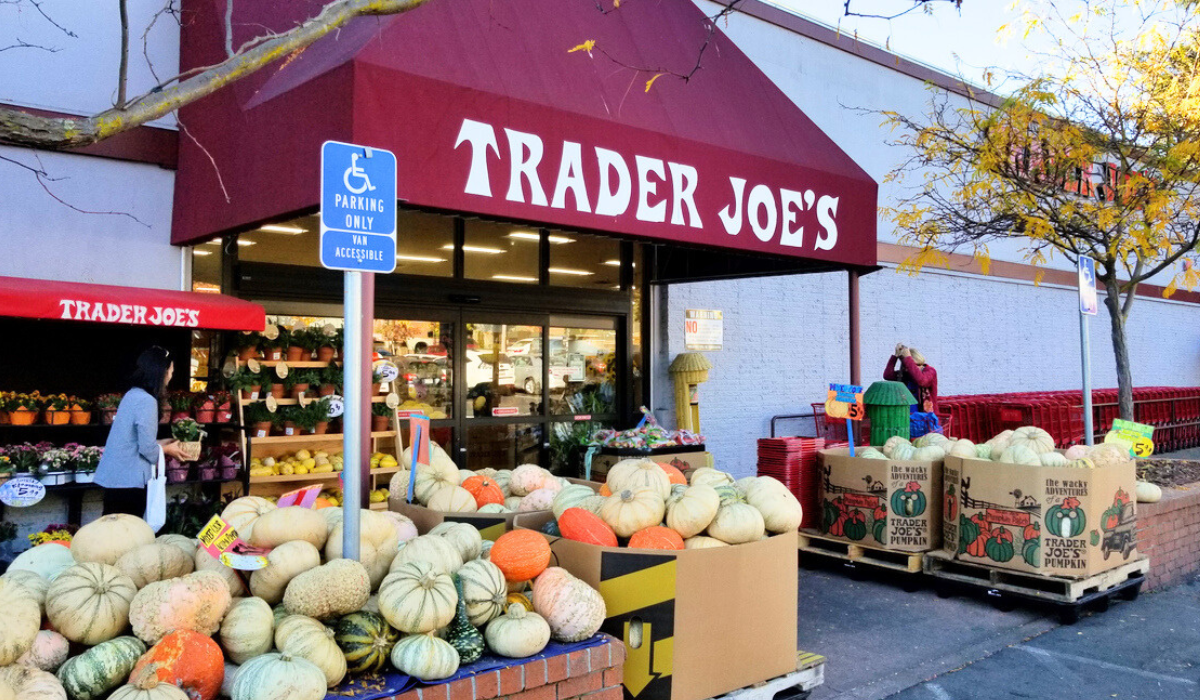 trader joe's store with a display of pumpkins outside