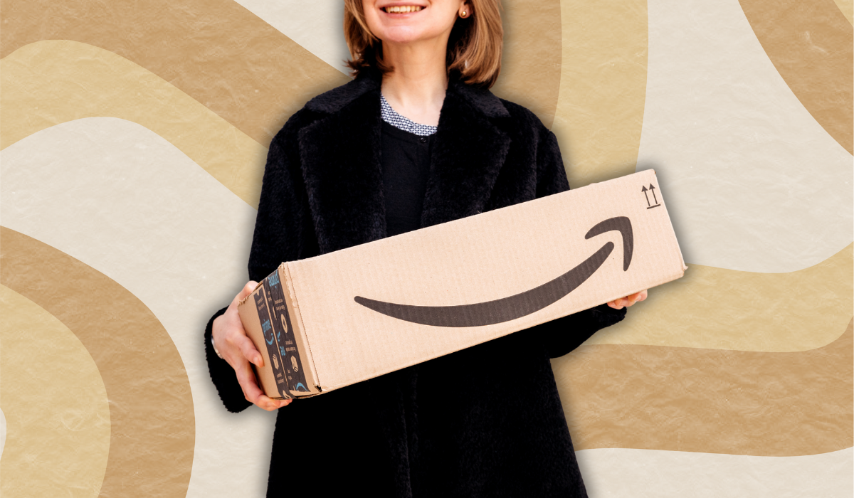 woman in a black sweater holding an amazon box against a beige swirly background