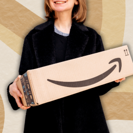 woman in a black sweater holding an amazon box against a beige swirly background