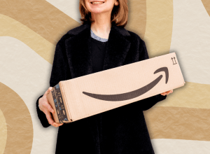 woman in a black sweater holding an amazon box against a beige swirly background