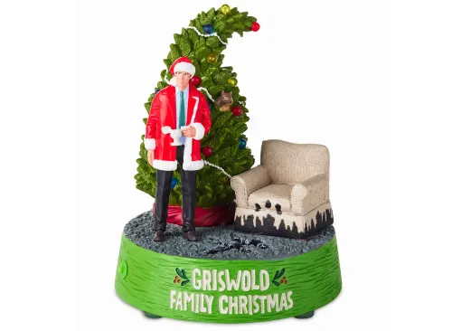 Light-Up Clark Griswold, Tree and Chair Figurine Back image number 2 Light-Up Clark Griswold, Tree and Chair Figurine Front glowing image number 3 Light-Up Clark Griswold, Tree and Chair Figurine closeup detail image number 4 Light-Up Clark Griswold, Tree and Chair Figurine upclose detail image number 5 Light-Up Clark Griswold, Tree and Chair Figurine package front image number 6 Light-Up Clark Griswold, Tree and Chair Figurine package back image number 7 National Lampoon's Christmas Vacation™ Griswold Family Christmas Figurine With Light and Sound