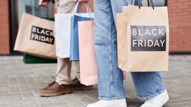 people walking with Black Friday shopping bags