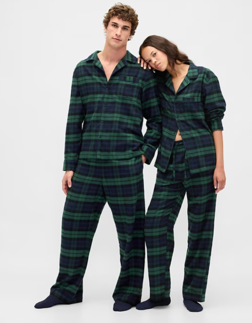 man and woman in green flannel PJs