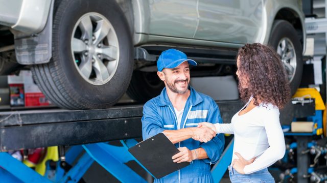 A mechanic shaking hands with a female customer