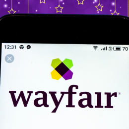 wayfair logo on phone with a purple festive background