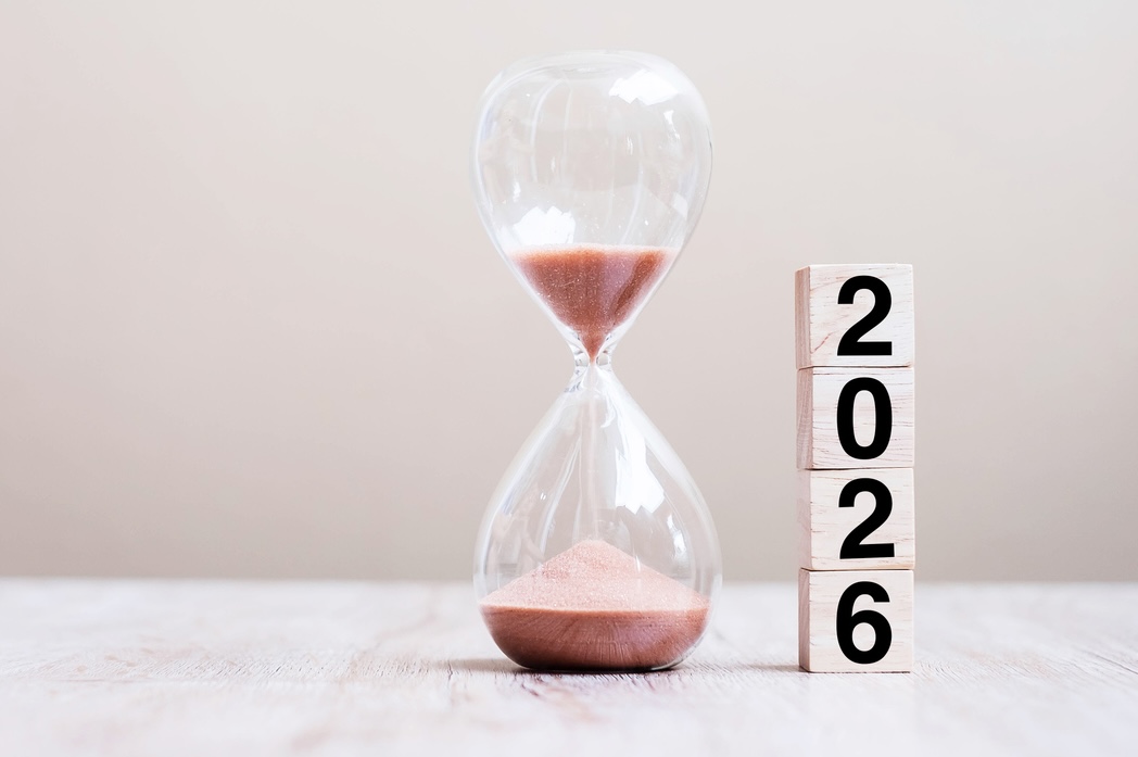 2026 text with hourglass on table.
